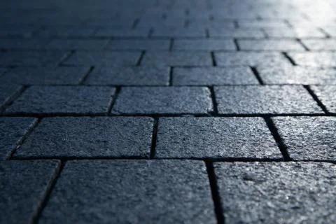 Dark grey granite rectangular pavement close-up Stock Photos