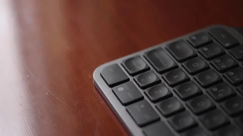 Dark Grey Keyboard Over A Glossy Wooden Desk Reflection Of A Window Stock Footage 328709093