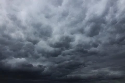 Dark grey rainy clouds in the sky Stockfoto's