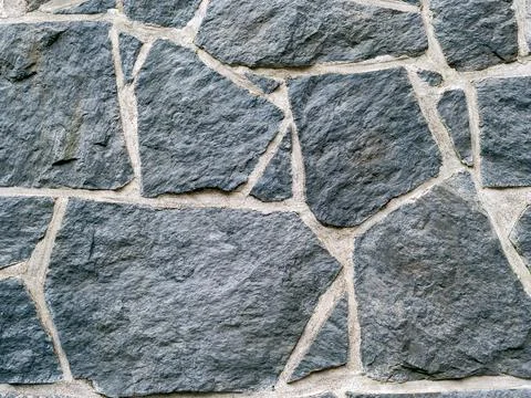Dark grey rocks texture background. Black rock wall texture Stock Photos