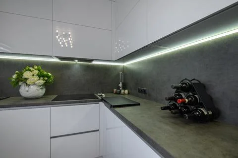 Dark grey stone counter work top at white trendy kitchen Stock Photos