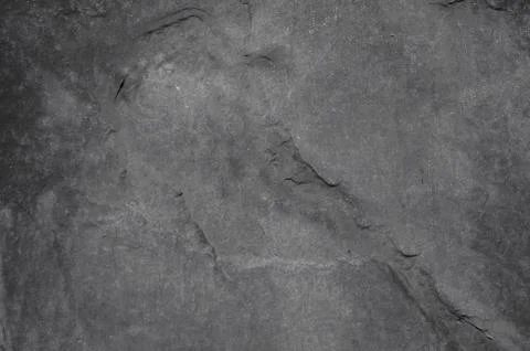 Dark grey stone with a rough sharp surface Stock Photos
