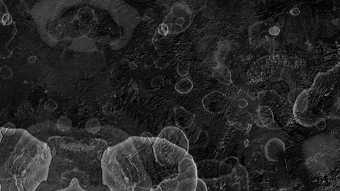 Dark grey textured surface with numerous small rounded bubbles Stock Footage 327882554