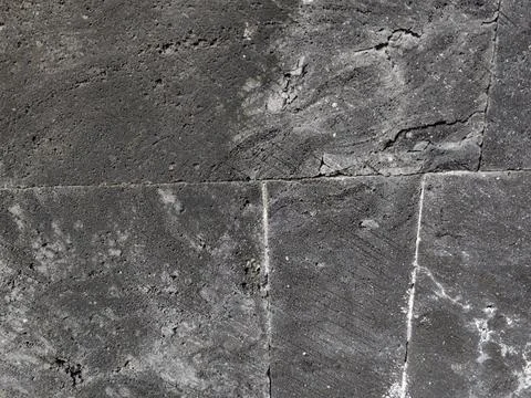 Dark grey volcanic basalt stone wall texture background. Stock Photos