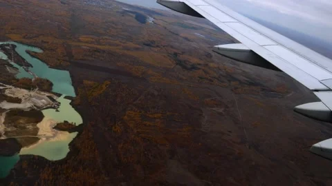 The dark ground is visible from a flying plane Stock Footage 167022781
