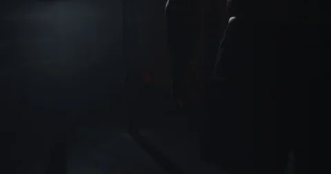 In a dark gym class athletic strong guy starting his hard work training , he Stock Footage 125479045