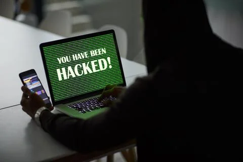 Dark, hacker and man with laptop and phone for online fraud, cybersecurity .. Stock Photos