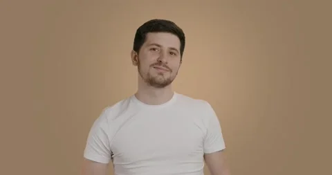 Dark-haired bearded man uses electric clipper to shave the cut hair off his chin Stock Footage 222446895