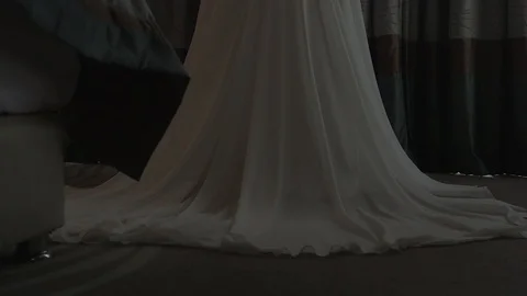 Dark-haired bride near the window in hotel room opening the curtain Stock Footage 94212236