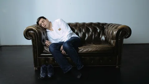 Dark Haired Caucasian Man Waking Up After Nap on Couch Stock Footage 120420258