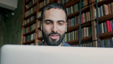 Dark-Haired Guy Using Laptop In Room With Many Books. Stock Footage 140224657
