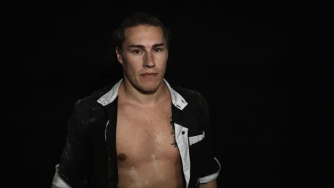 Dark haired man abruptly slaps himself in face with hand holding white powder. Stock Footage 95420595