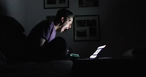 Dark-haired man screams furiously in front of laptop screen Stock Footage 130489261