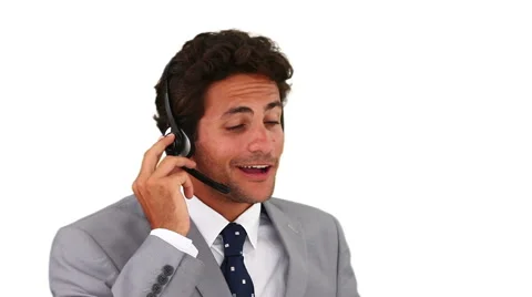 Dark-haired man talking on the phone in a call center Stock Footage