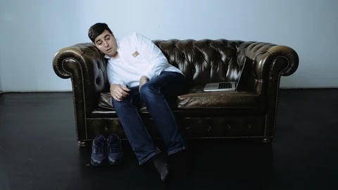Dark Haired Man Waking Up After Nap on Couch Begins Using Laptop Stock Footage 120420695
