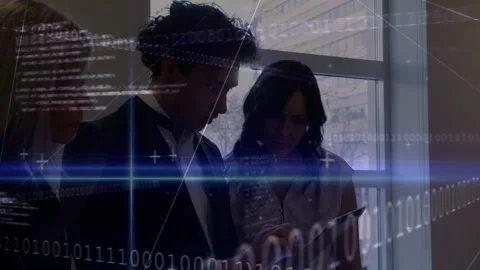 Dark-haired woman tapping tablet and man tilting tablet, code overlay pulsing Stock Footage 313307743