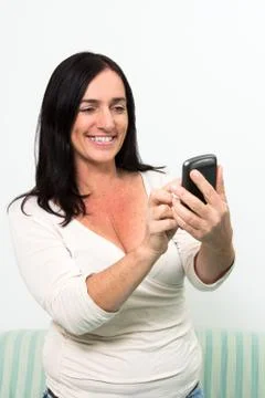 Dark haired woman using a smartphone Stock Photos