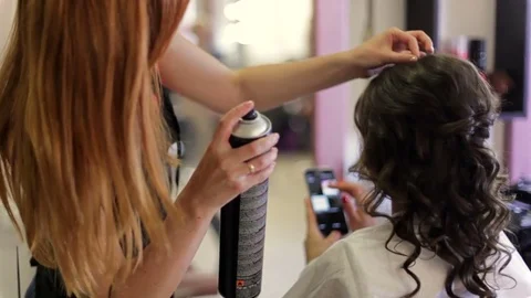 Dark haired young woman does a hairdress in a hairdresser. close up Stock Footage 82972147