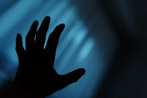 Dark hand shadow reaching into the unknown Photos