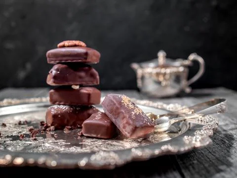Dark handmade chocolate stack with cacao chips and nuts Stock Photos