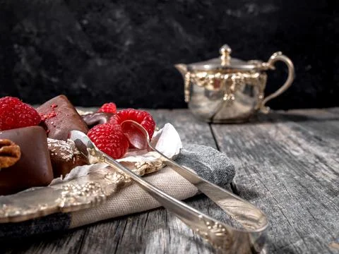Dark handmade chocolate stack with raspberries and nuts Stock Photos