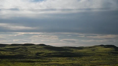 Dark, heavy clouds race across the sky in a dramatic time-lapse, casting Stock Footage 329072103