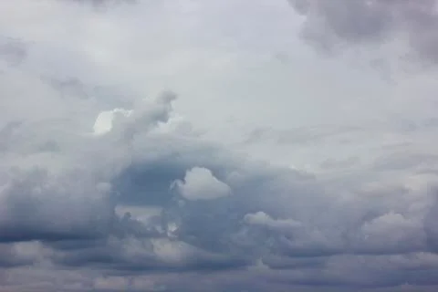 Dark heavy clouds. Rain clouds. Time before the rain. There are bright gaps b Stock Photos