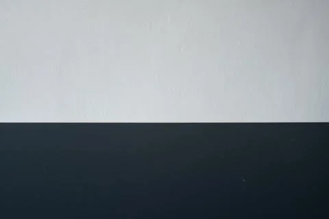 Dark horizontal table surface adjacent to the white wall Stock Photos