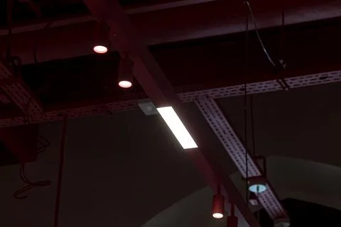 Dark industrial ceiling with hanging lights Stock Photos
