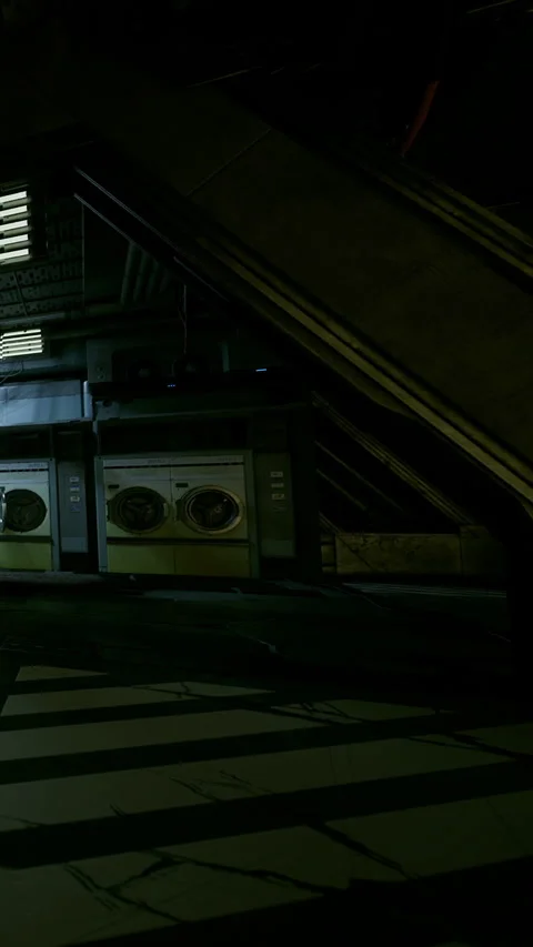Dark industrial space with laundry machines and stairs in the background Stock Footage 339939828