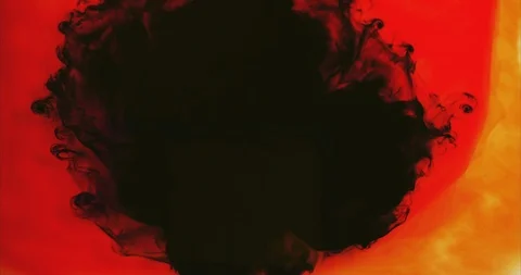 Dark ink exploding on colorful red and yellow background Stock Footage 88099257