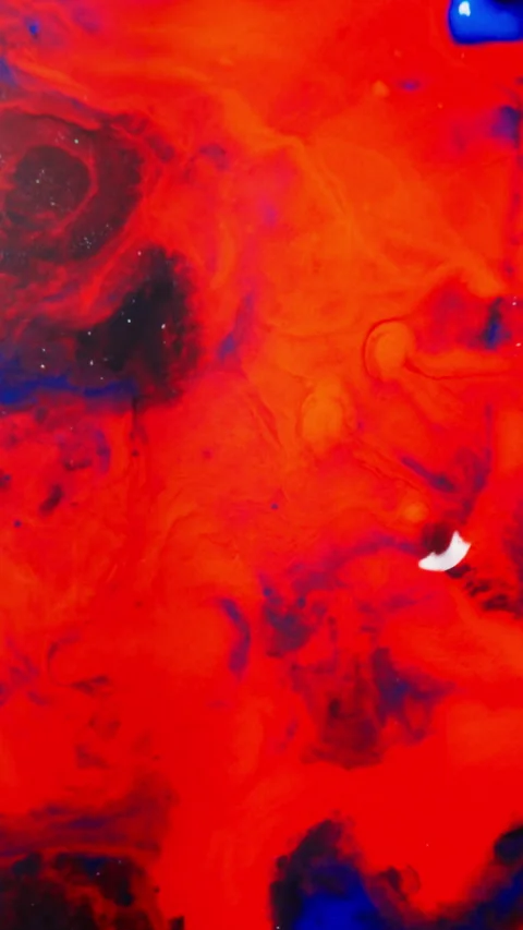 Dark Ink Swirling and Spreading in Red Liquid Creating Abstract Cosmic Patterns Stock Footage 340882005