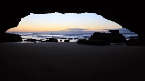 Dark inside sea cave at Caves beach of Australia on Pacific coast sunrise. Stock Footage 242582953