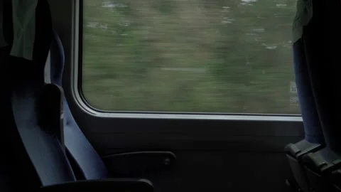 Dark interior of moving high-speed train carriage with empty seats. view from Video stock 159168789