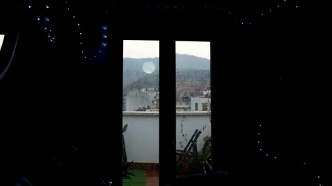 Dark interior with silhouette and rain on window Stock Footage 323937780