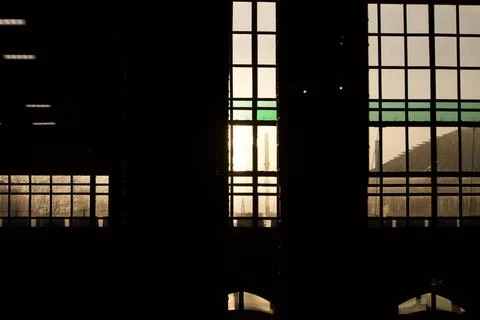 Dark interior with sunset light through windows Stock Photos