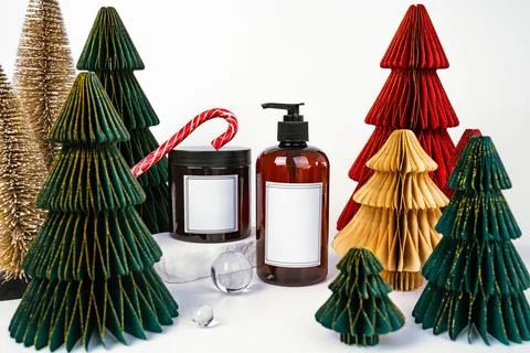 Dark jar with lid and dispenser on the background of Christmas decorations, side Stock Photos