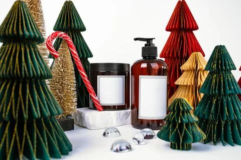 Dark jar with lid and dispenser on the background of Christmas decorations, side Stock Photos