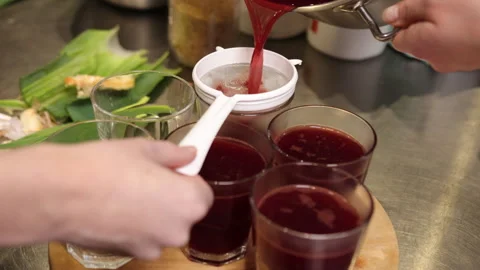 Dark juice, kitchen tools, juice strainer Stock-Footage 284257330