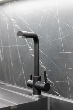 Dark kitchen faucet with filtered water function Stock Photos