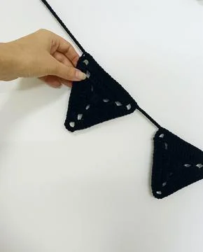 Dark knitted garland with triangular flags.  Fotos Stock