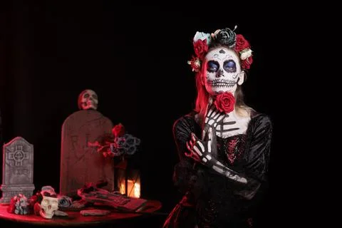 Dark lady posing with red rose during Day of the Dead event Stock Photos