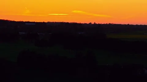 Dark landscape under a bright orange sky. Stock-Footage 332747109