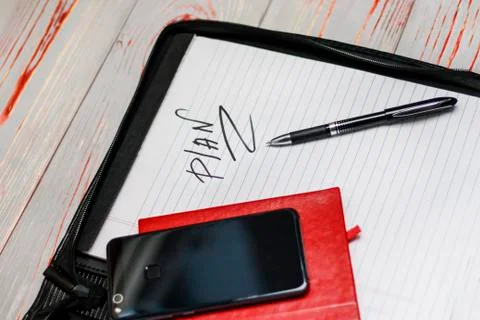 Dark leather bag for documents. in it the inscription of the word plan. There 스톡 사진