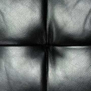 Dark leather texture of sofa closeup shot Stock Photos
