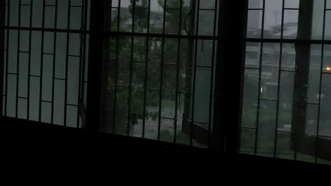 Dark Lonely Rainy Day View Through Old Window Bars with Rain Droplets Stock Footage 339859674