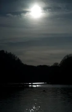 Dark looking sun shining on lock Stock Photos