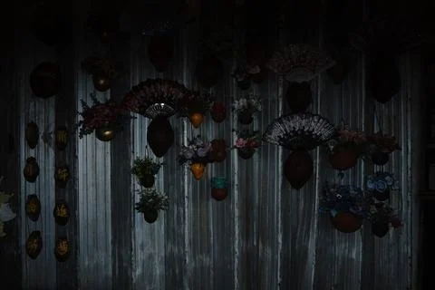 A dark low-key image featuring an arrangement of decorative fans artificial Photos
