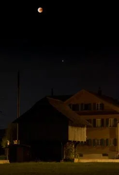 Dark lunar eclipse scenery in rural place lucerne Stock Photos