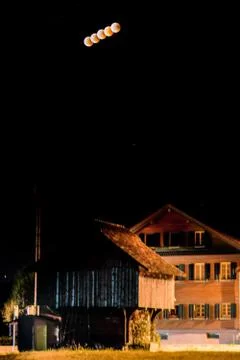 Dark lunar eclipse trail scenery in rural place lucerne Stock Photos